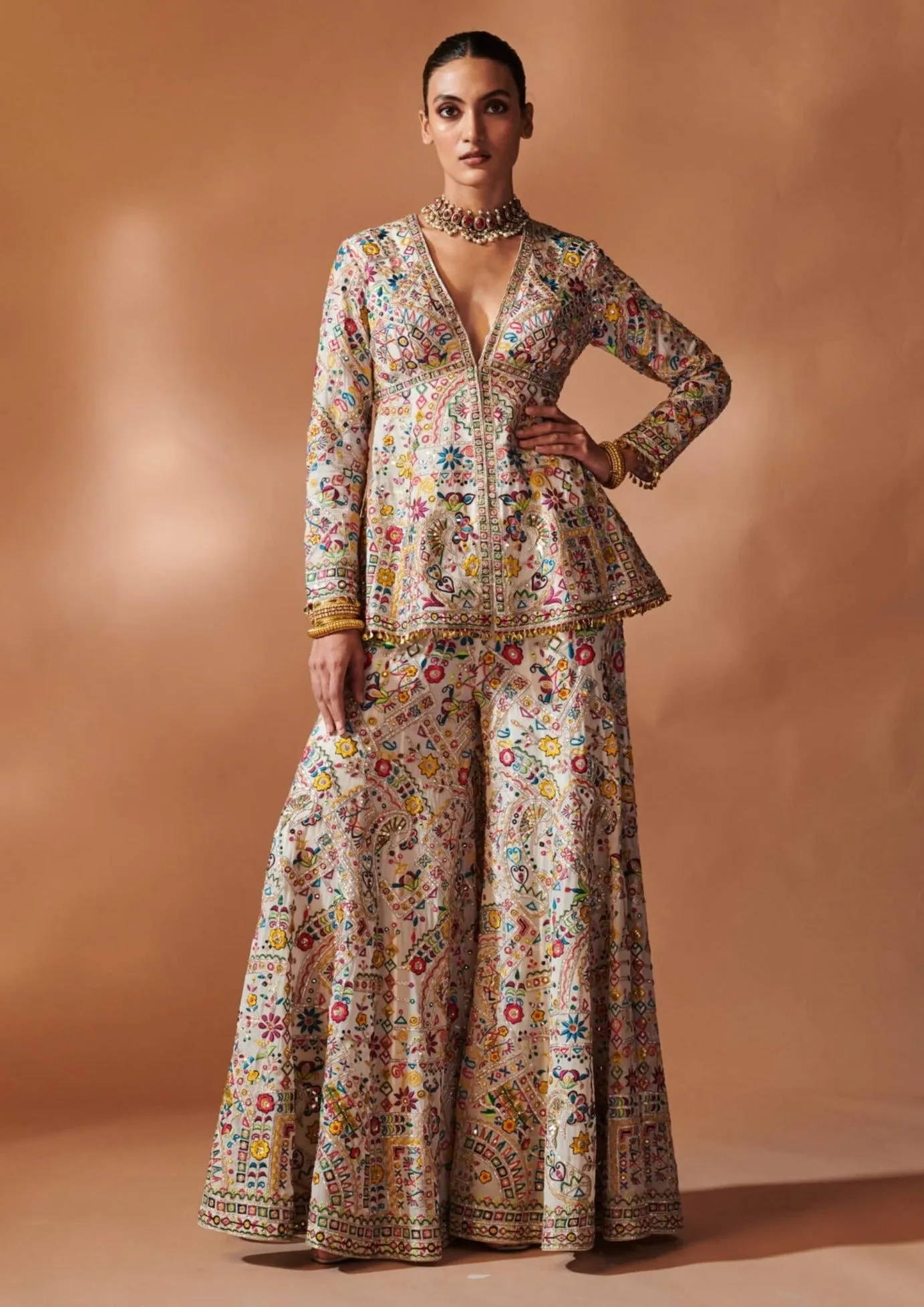 Ivory embroidered peplum sharara set