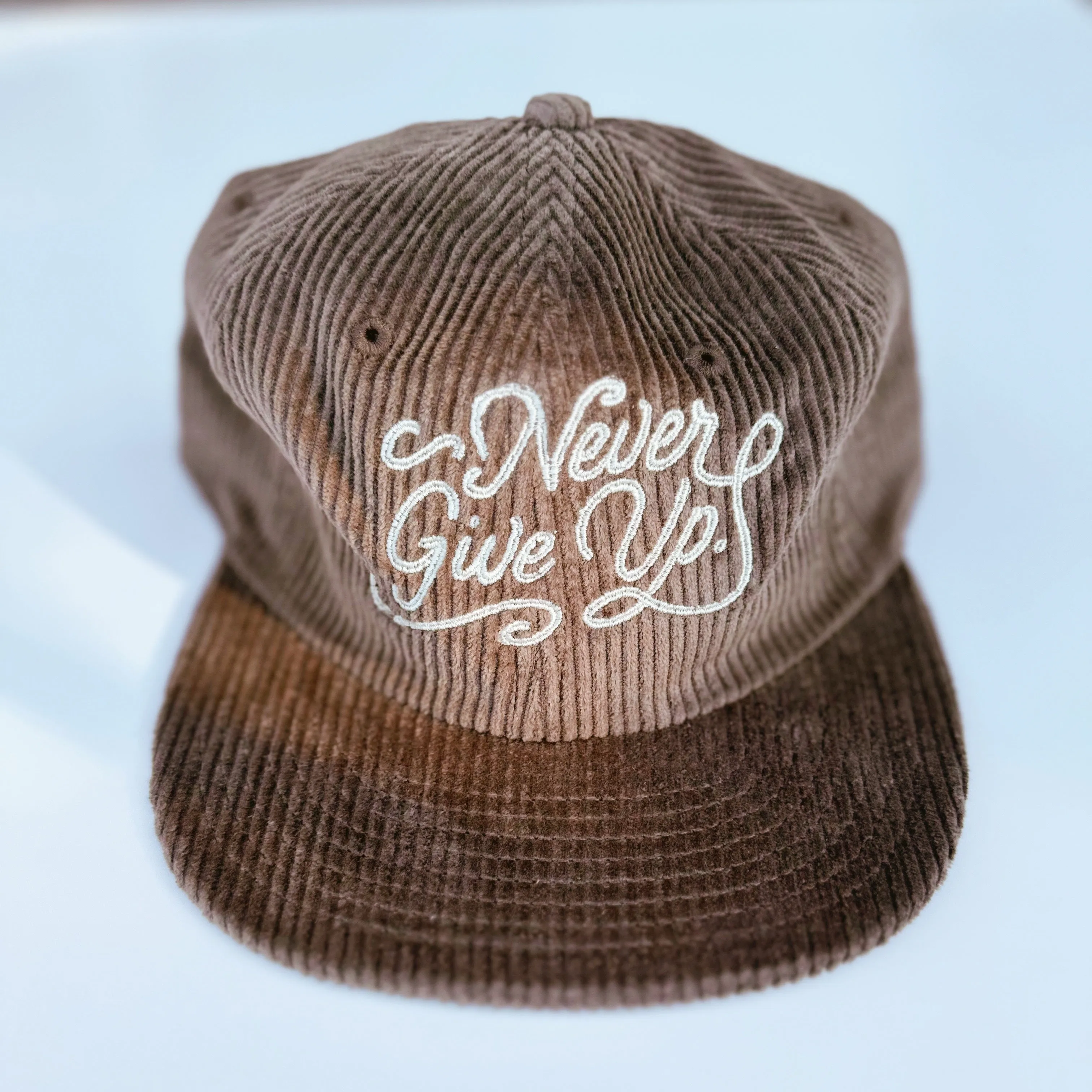 NEVER GIVE UP. CORD HAT