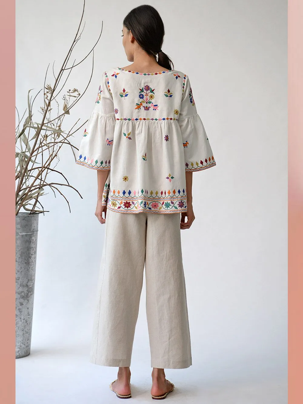 UMBAR by Payal Pratap   I   Top Mandvi  I  A Round Neck Tassle Tie Up Top With Peplum Sleeves And Intricate Thread Multicolour Embroideries From The Kutch Region  I  Perfect For Your Summer Day Out As Well As That Beach Getaway