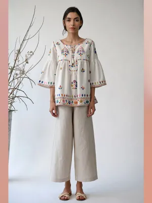 UMBAR by Payal Pratap   I   Top Mandvi  I  A Round Neck Tassle Tie Up Top With Peplum Sleeves And Intricate Thread Multicolour Embroideries From The Kutch Region  I  Perfect For Your Summer Day Out As Well As That Beach Getaway