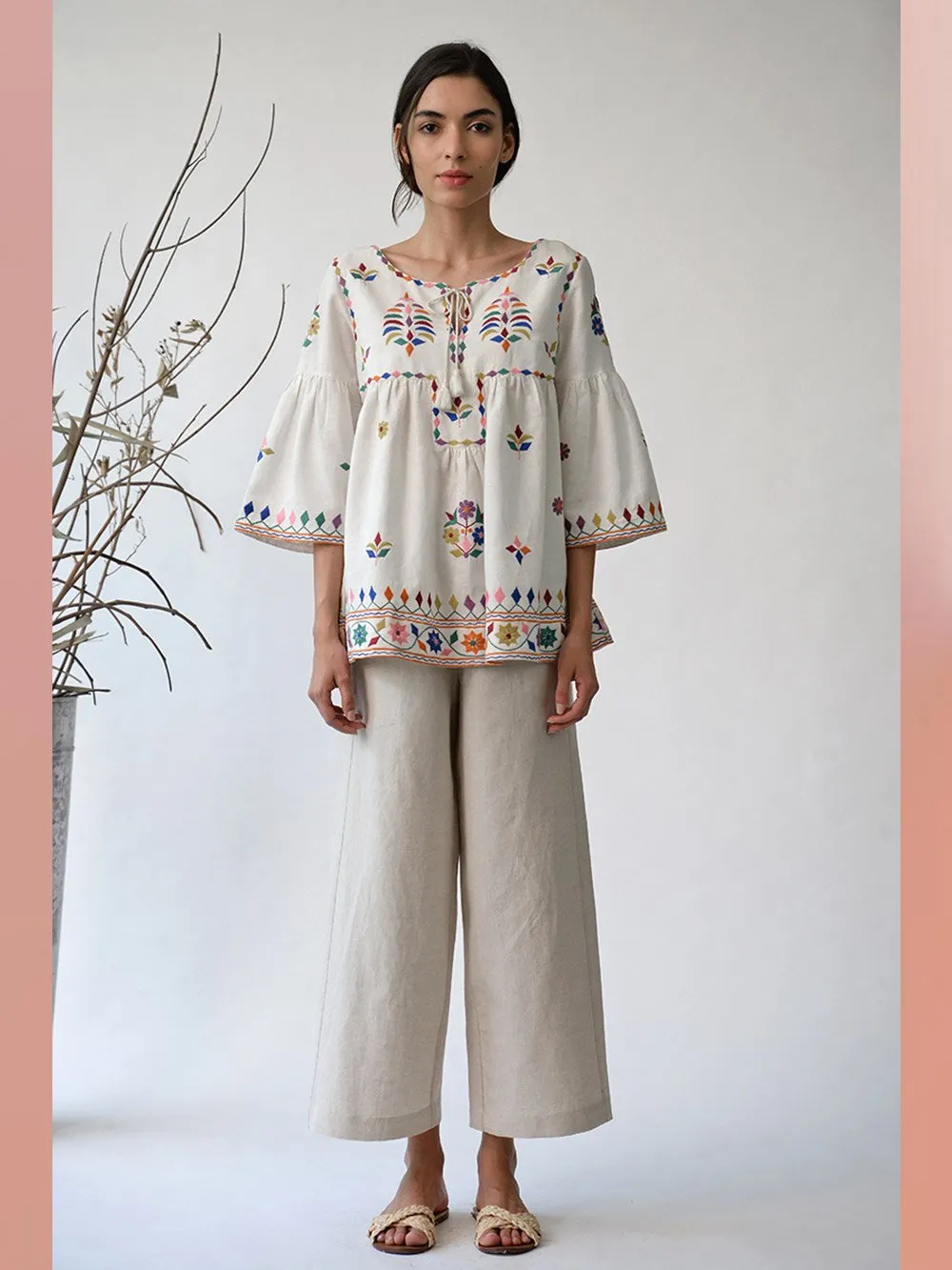 UMBAR by Payal Pratap   I   Top Mandvi  I  A Round Neck Tassle Tie Up Top With Peplum Sleeves And Intricate Thread Multicolour Embroideries From The Kutch Region  I  Perfect For Your Summer Day Out As Well As That Beach Getaway